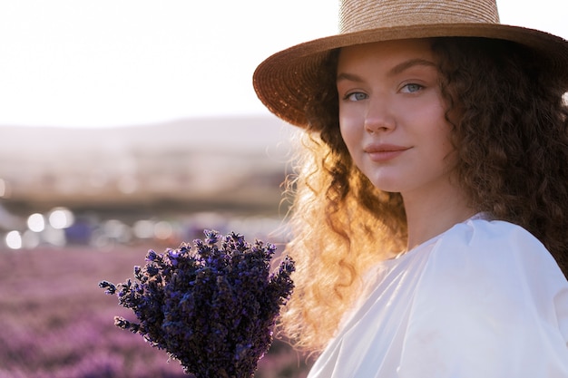 Side view smiley woman holding lavender