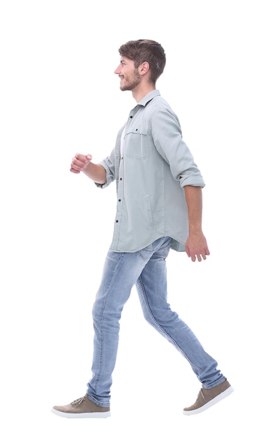 Side view a smiling young man steps forwardisolated on white background