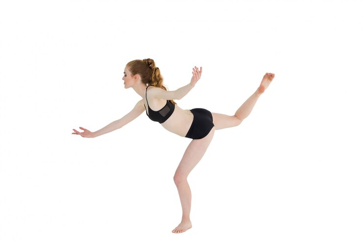 Photo side view of sporty woman standing on one leg