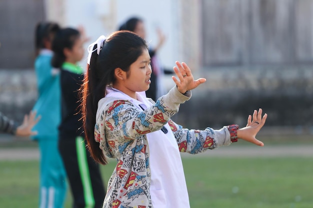 Side view of teenage girl dancing on field