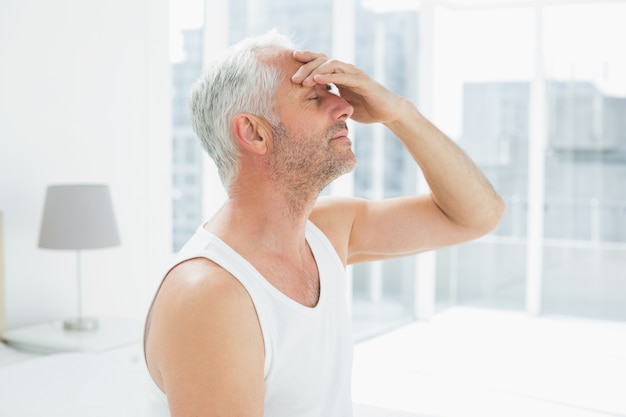 Side view of a thoughtful mature man in bed