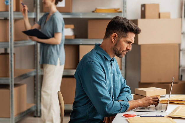 Side view warehouse with employees for delivery service