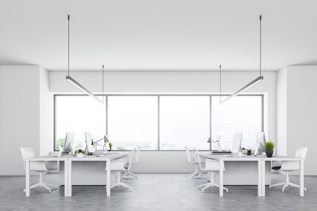 Side view of a white open space modern company office with a concrete floor, large windows and rows of computer tables. 3d rendering mock up