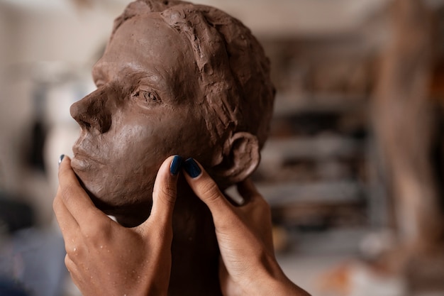 Side view woman clay sculpting