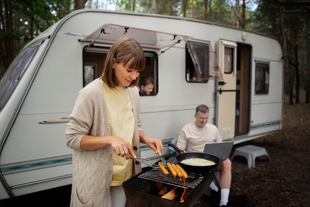 Side view woman cooking in nature