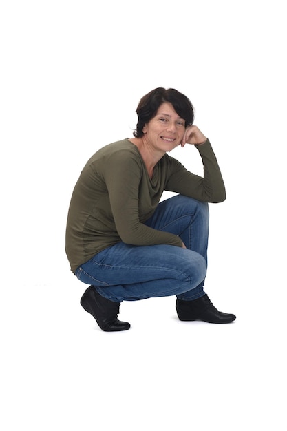 Side view of a woman crouching and hand on face on white background