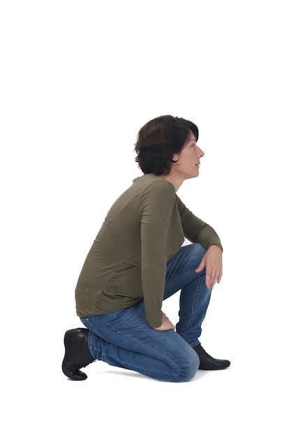 Side view of a woman crouching on white background