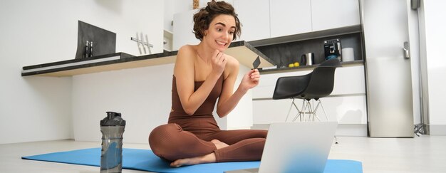 Side view of woman exercising in gym