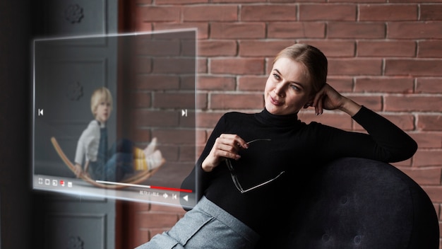 Side view woman looking at floating screen