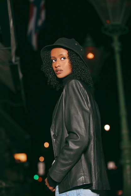 Side view woman posing at night with flash