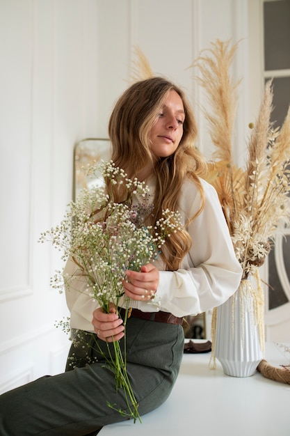 Side view woman posing with flowers