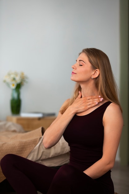 Photo side view woman practicing facial yoga