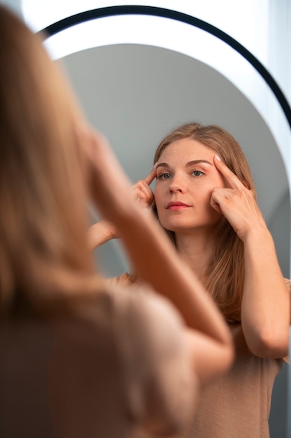 Photo side view woman practicing facial yoga