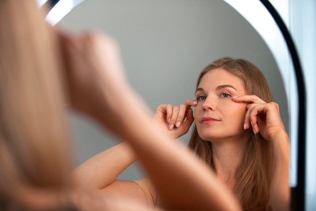 Photo side view woman practicing facial yoga