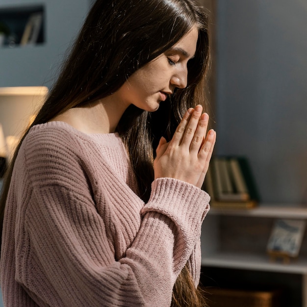 Side view of woman praying