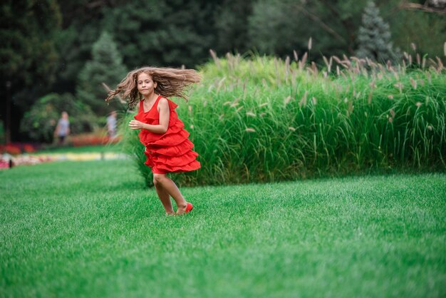 Side view of a woman running on grass