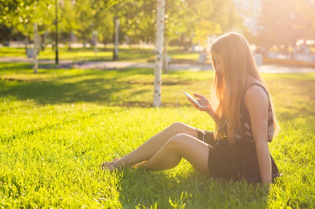 Side view of woman sitting on field