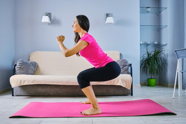 Side view of woman sitting on floor