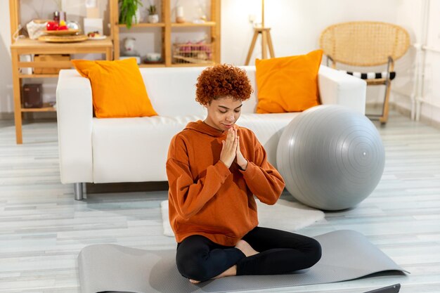 Side view of woman sitting on sofa at home