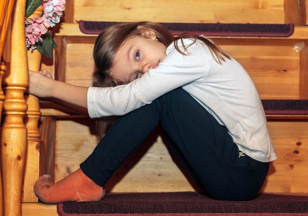 side view of woman sitting on steps