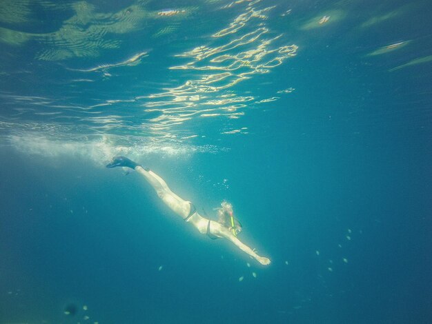 Side view of woman snorkeling in sea