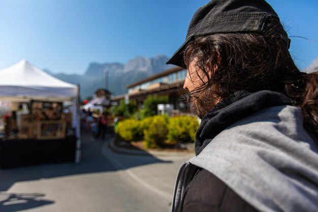 Side view of woman on street against sky