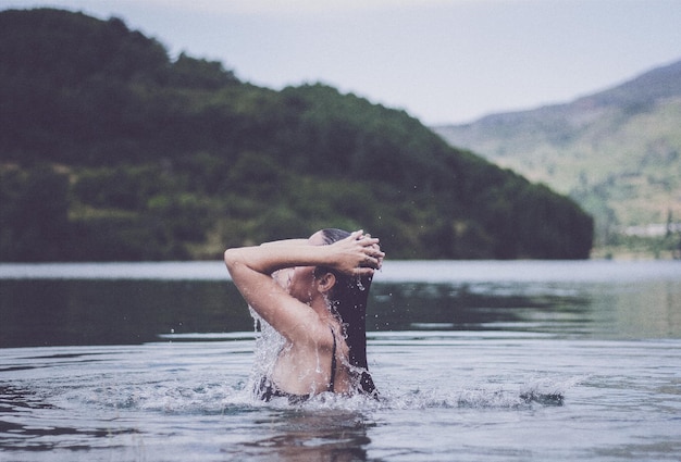 side view of woman swimming in lake