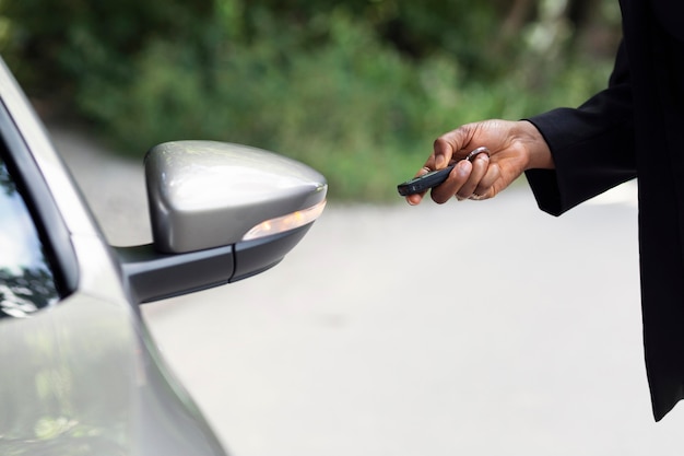 Side view of woman testing the keys to her brand new car