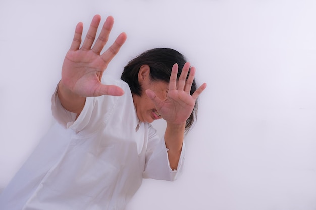 Side view A woman trying to protect her head with both hands