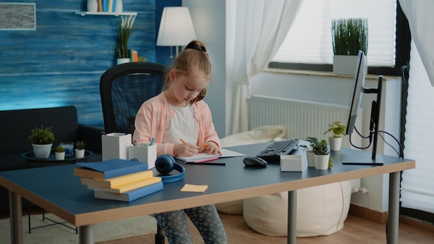 Side view of woman using laptop at home