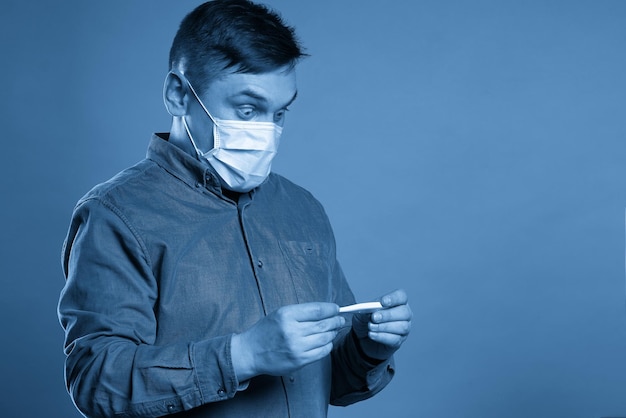 Side view of woman using mobile phone against blue background