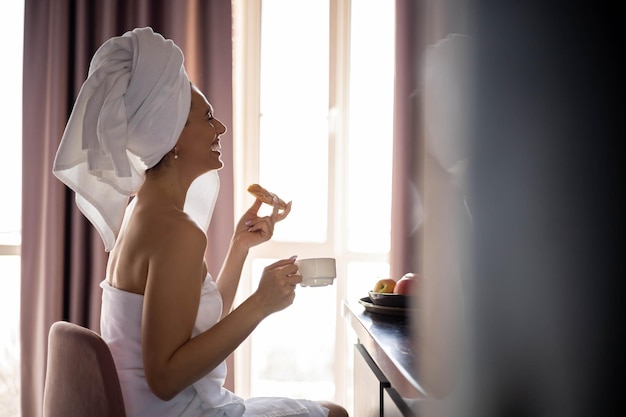 Side view of woman using mobile phone at home