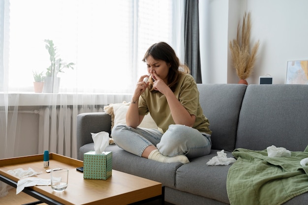 Side view woman using nasal spray