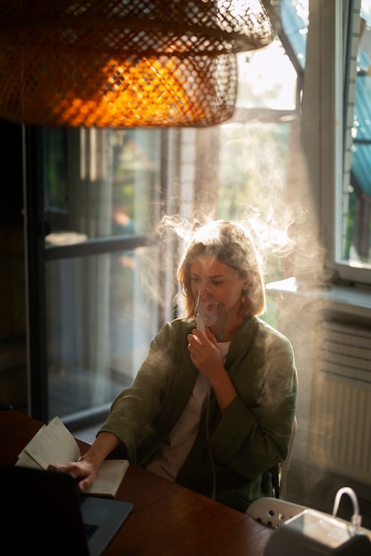 Side view woman using nebulizer