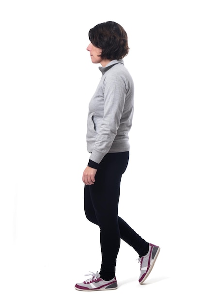 Photo side view of a woman walking on white background,