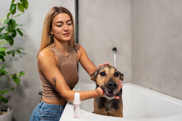 Side view woman washing dog