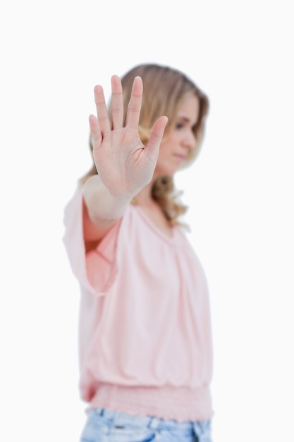 Side view of a woman with her hand held up to the camera