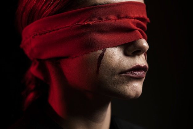 Side view of woman with red blindfold