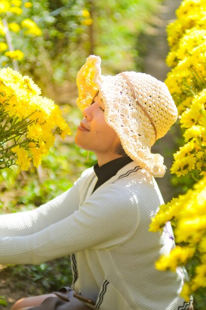 Side view of woman with yellow flowering plants
