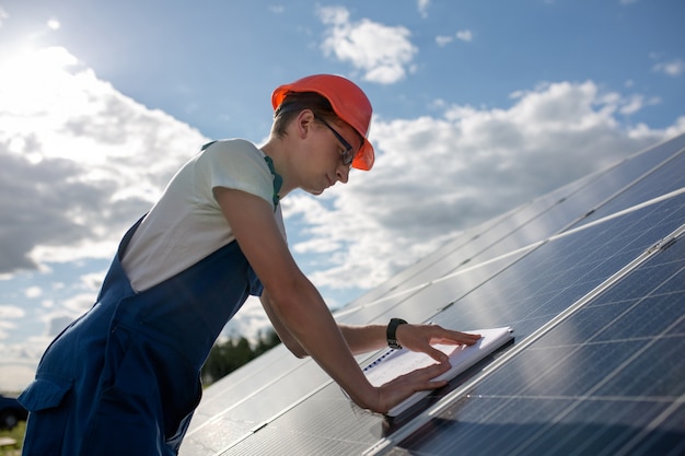 Side view on worker and solar panel.