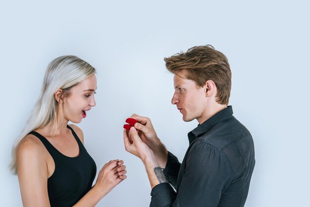 Side view of young couple against white background