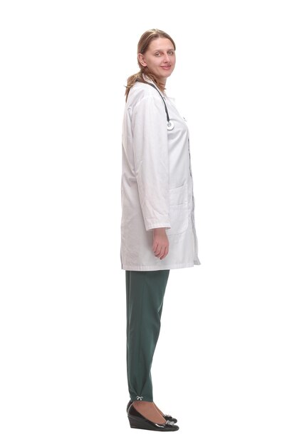 Side view of young female doctor or nurse standing over white background thoughtfully