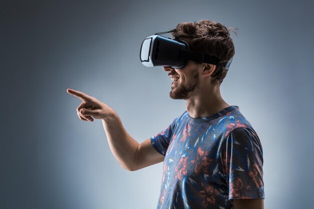 Side view of a young guy using a vr headset emotions