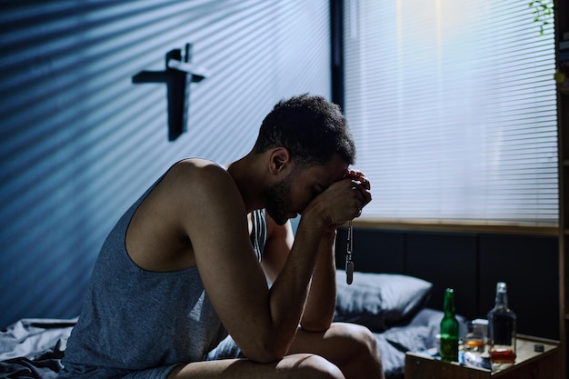 Photo side view of young inconsolable man with post traumatic syndrome