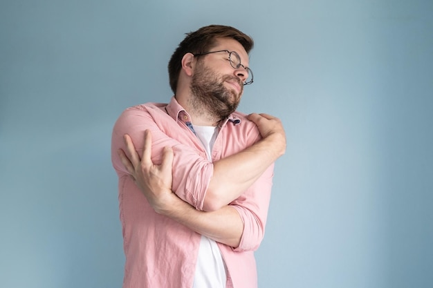 side view of young man against blue background