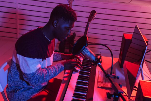 Side view of young man playing piano