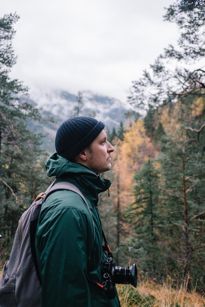 side view of young man standing in forest