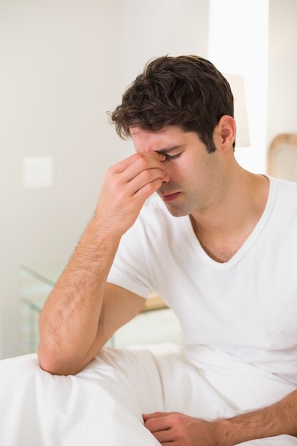 Side view of a young man with eyes closed in bed