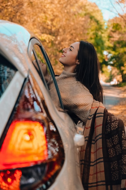 Foto vista laterale di una giovane donna in macchina