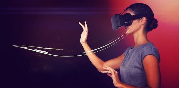 Side view of young woman gesturing while using virtual video glasses